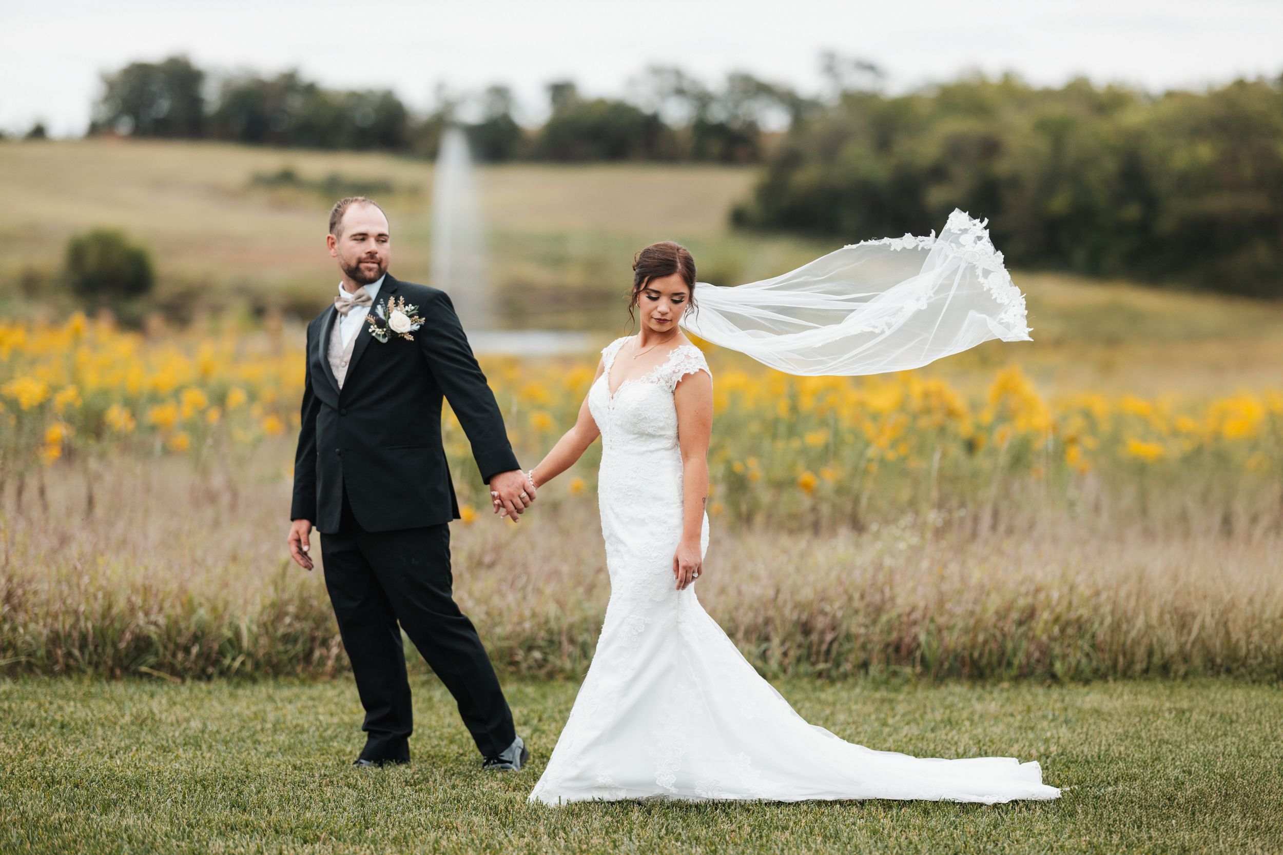 A collage of wedding photos showing a couple in formal attire walking through a scenic outdoor field with wildflowers.