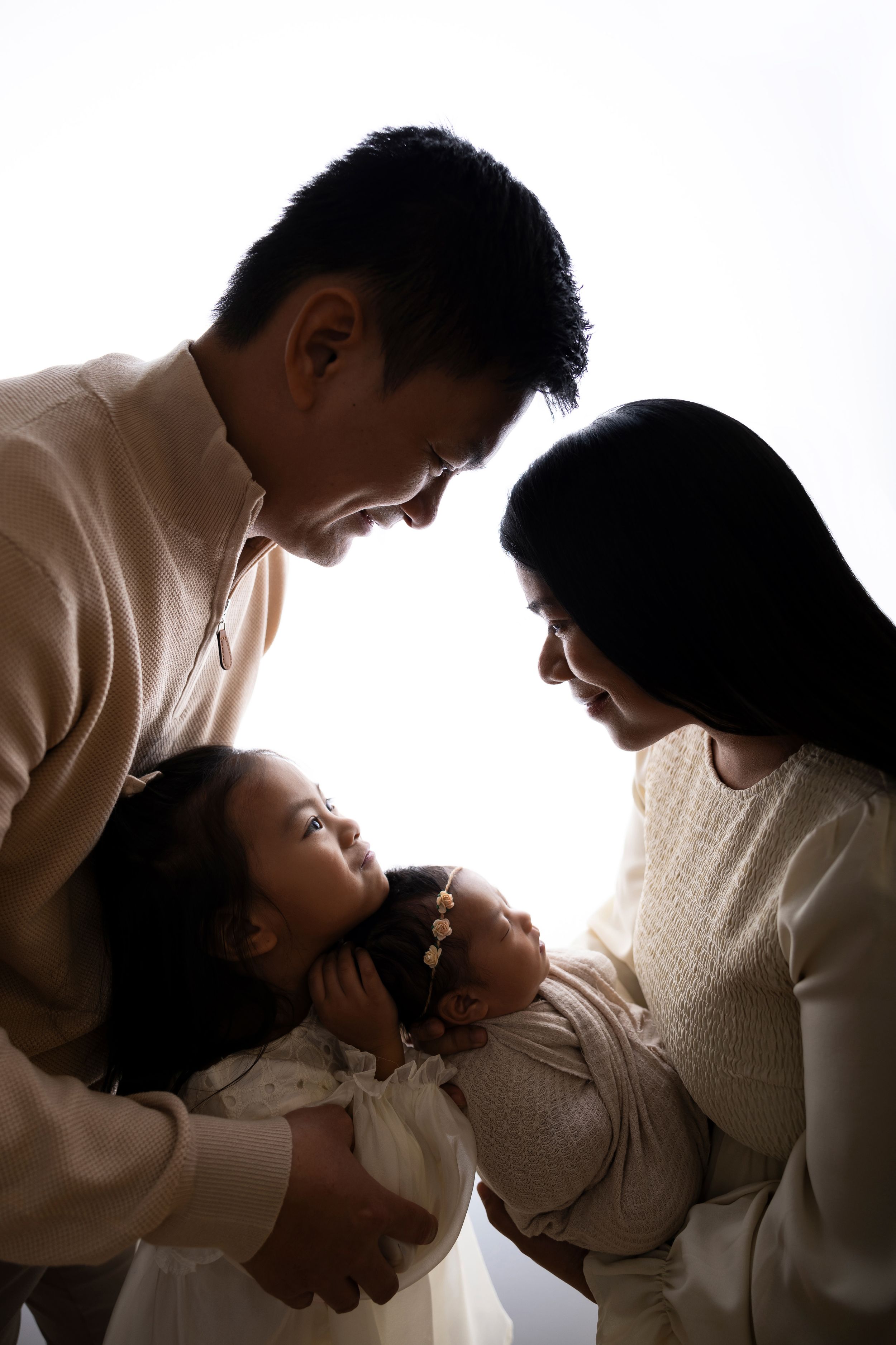 Silhouetted family portrait with parents in NJ photography studio located in Sussex County NJ.
