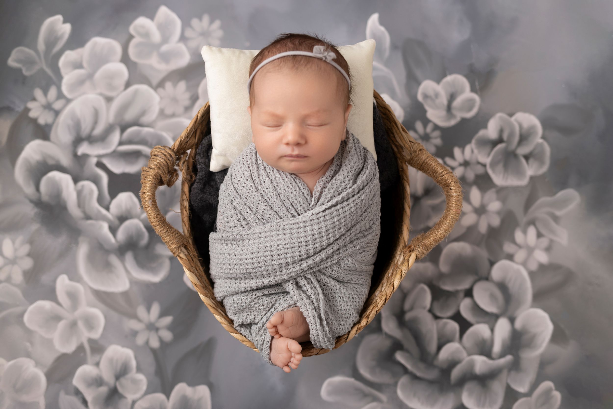 Newborn baby sleeping peacefully being photographed by a professional newborn photographer in Sussex County NJ