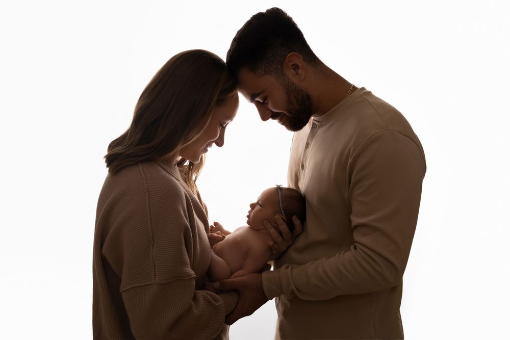 Silhouetted photo of family portraits in the studio in Newton, NJ - specializing in Newborn photography
