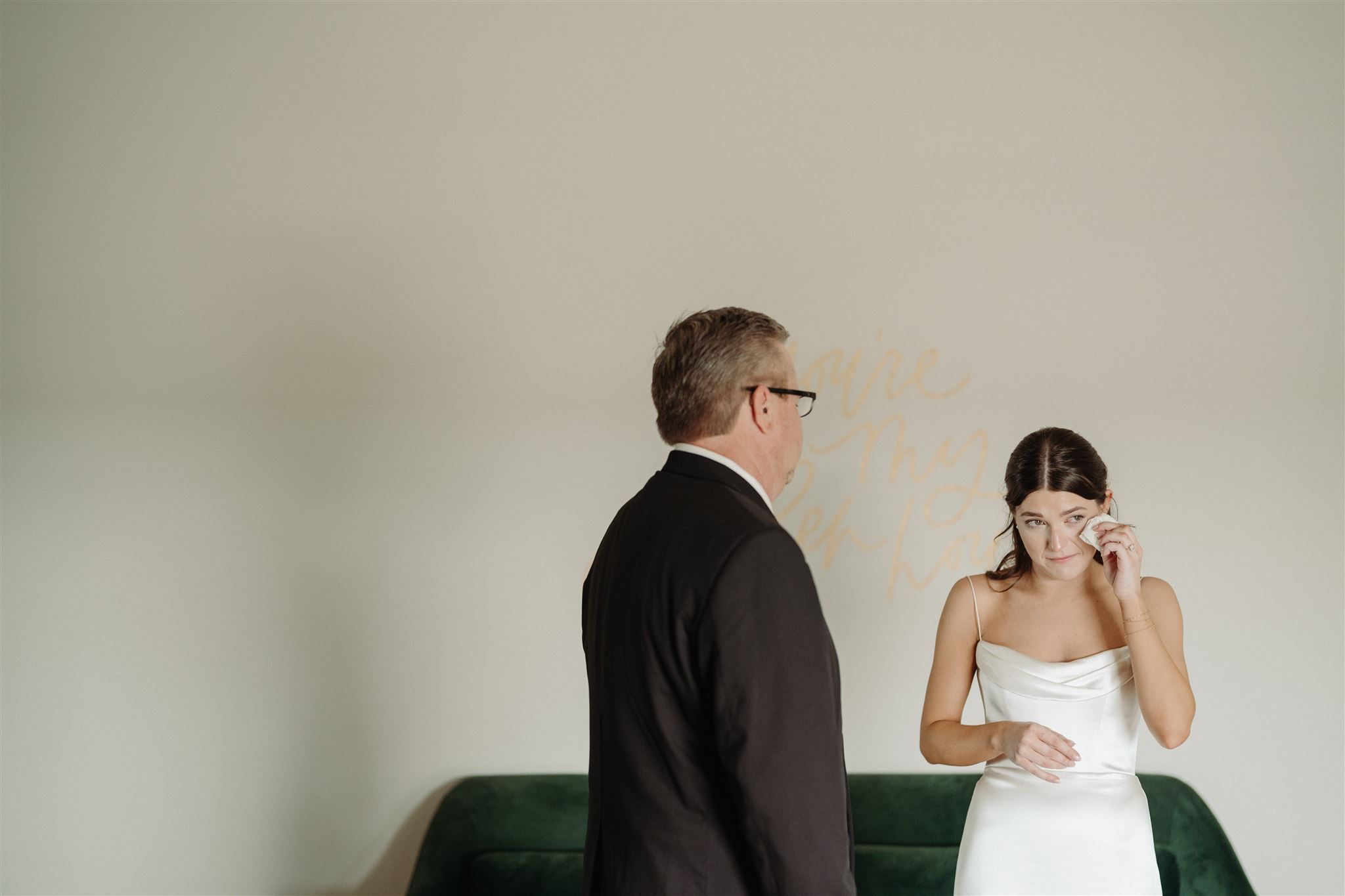 Intimate emotional moment during wedding preparations indoors.