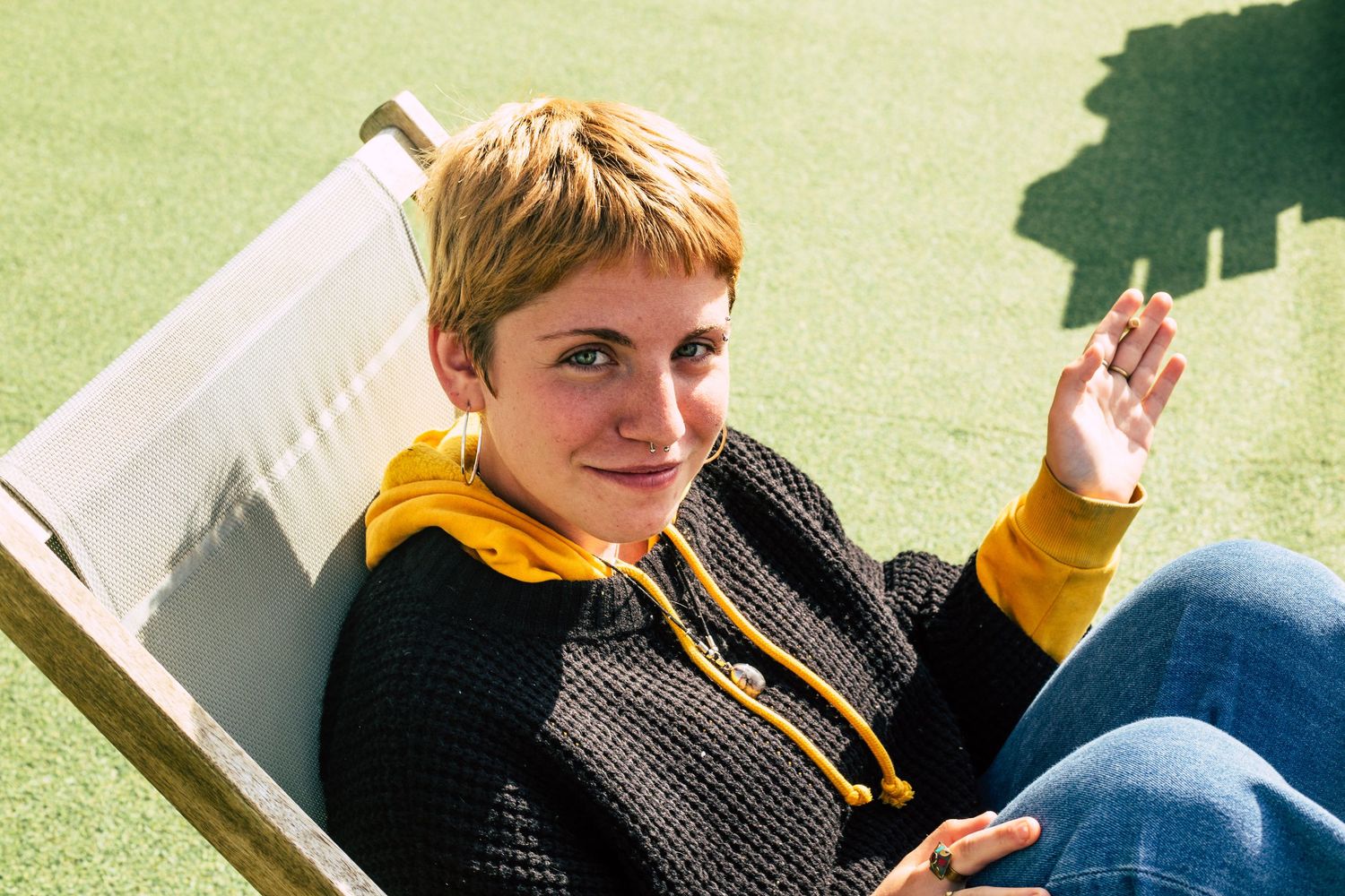 Multiple candid shots of people relaxing on grass in casual attire.