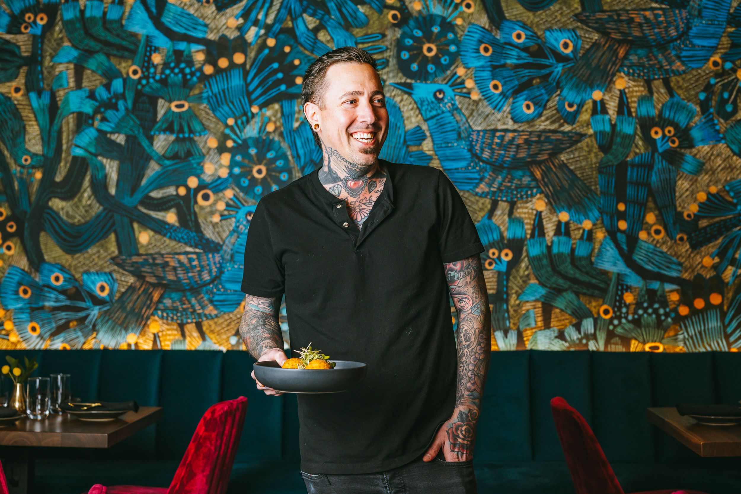 Restaurant setting with colorful mural artwork and plated food.