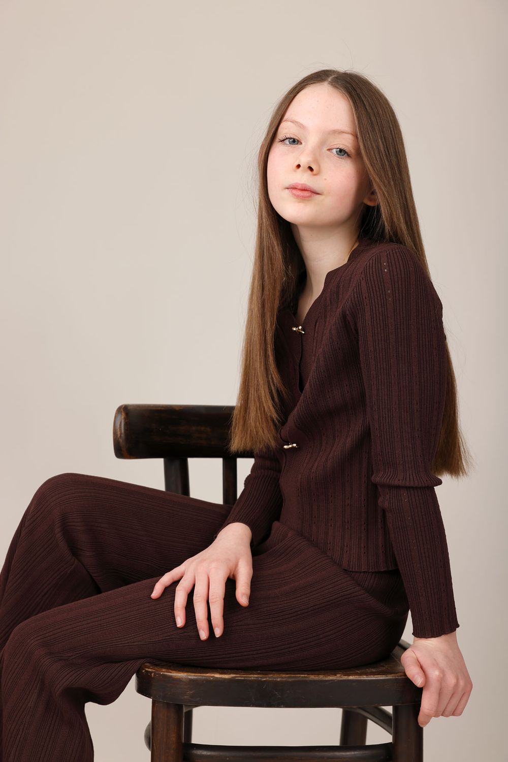 Child model portfolio update of a young girl seated on a chair, Abigail Stewart Photography, Buckinghamshire