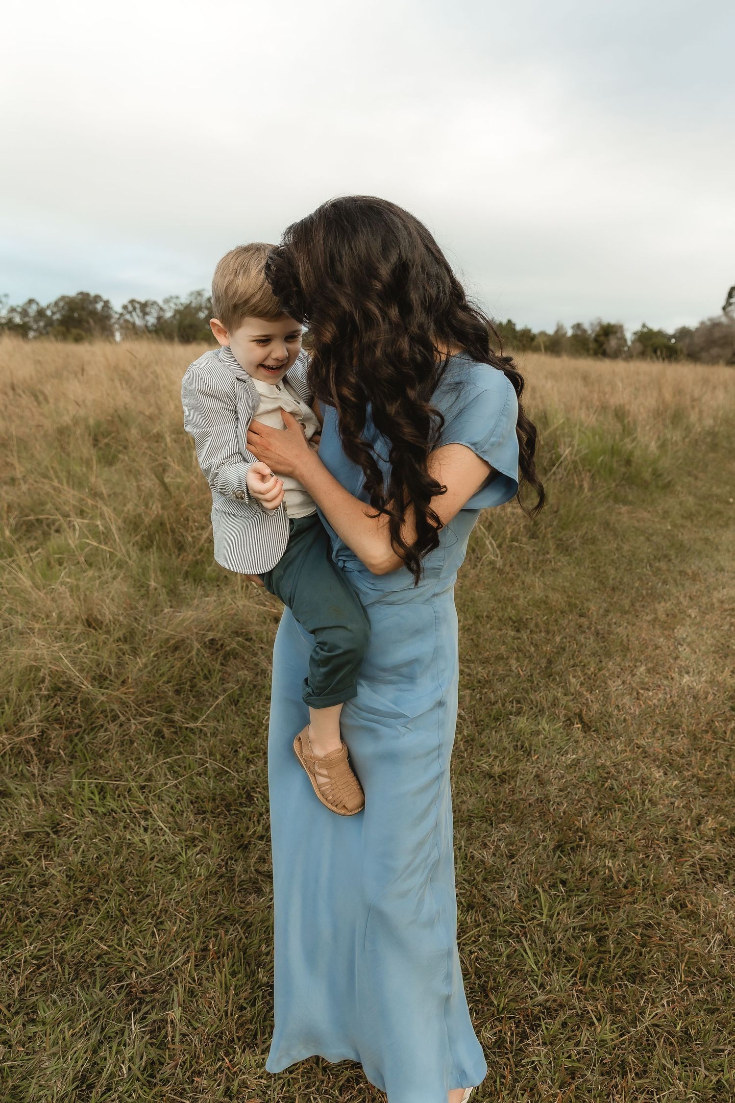 Sisters frolicking in waves during Brisbane family photo shoot
