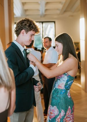 A couple shares an intimate dance moment at an elegant indoor venue in matching formal attire.