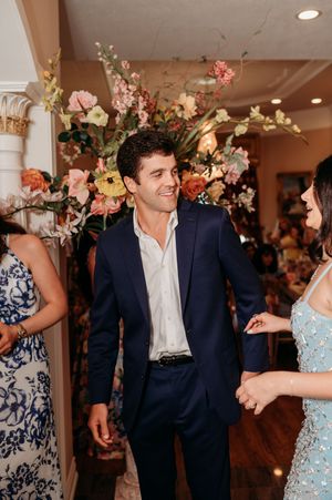 Wedding reception dance floor with floral decorations and festive lighting creating a romantic atmosphere.