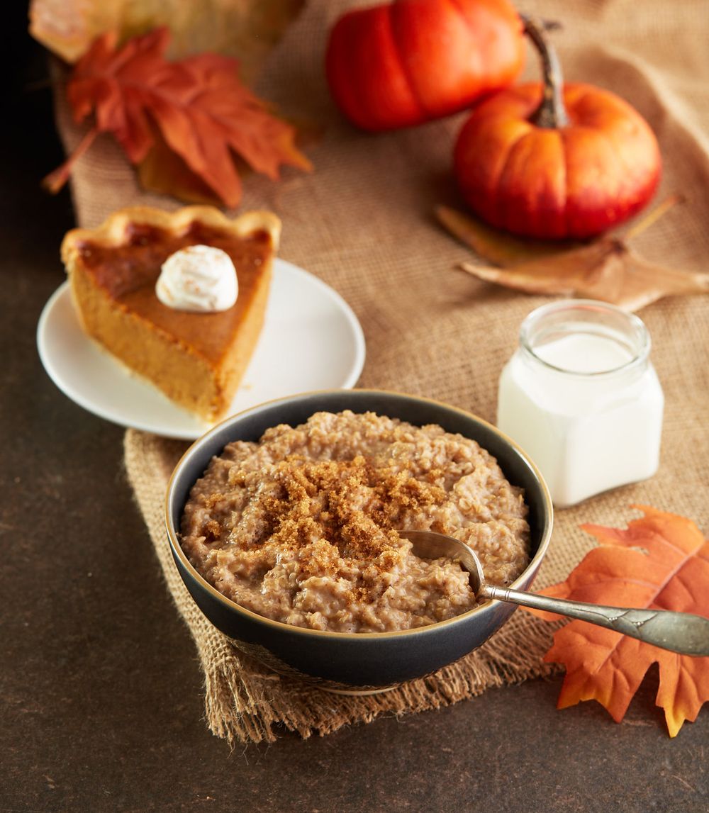 Pumpkin pie and oatmeal with fall decorations on a rustic table