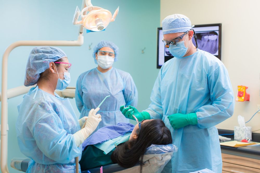 Medical professionals in protective gear working in a modern clinical setting.