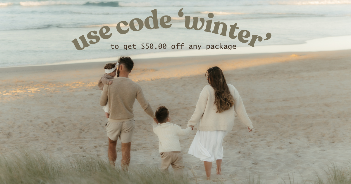 Family walking on beach in neutral tones, promoting a winter photography package discount of $50 off with code winter.