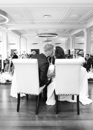 Mr. and Mrs. at the reception kissing at their sweetheart table. Des Moines Iowa Tea Room Wedding Photography