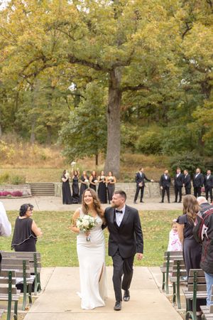 Wedding guests gather outdoors on a beautiful fall day in Des Moines, Iowa