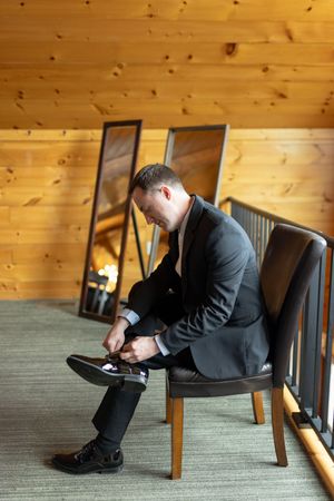 Groom getting ready for his wedding day in Adel, Iowa. Posing ideas for groom getting ready wedding photography