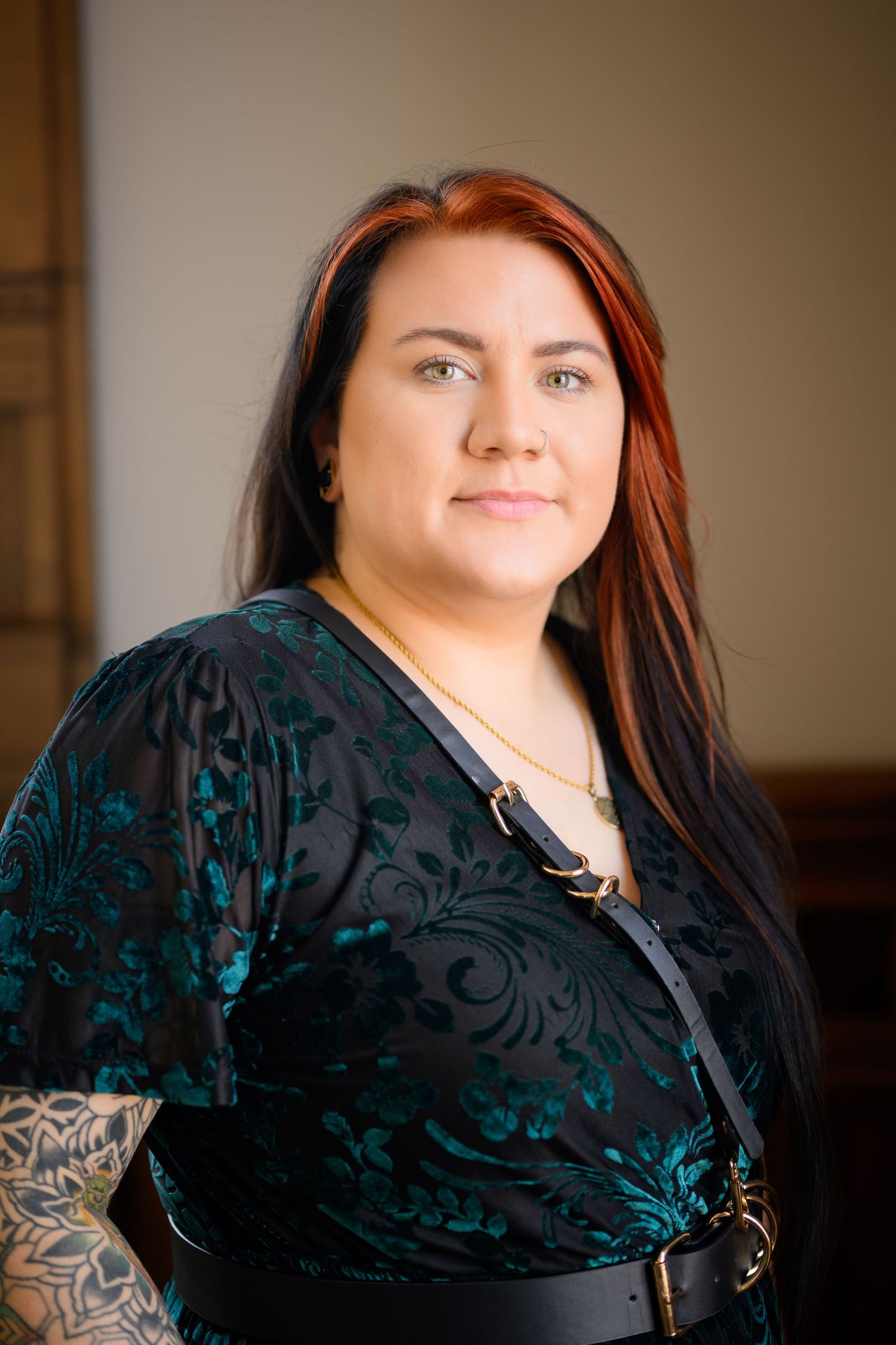 A person wearing a black velvet burnout shawl poses in a sequence of casual portraits against a warm-toned background.