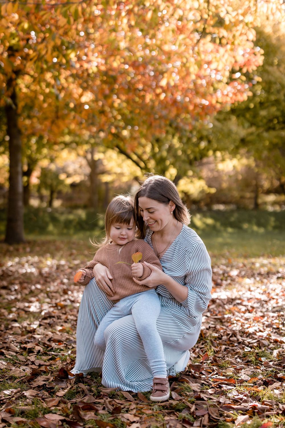 Mother and son in Autumn leaves, Dolbel Reserve, Napier