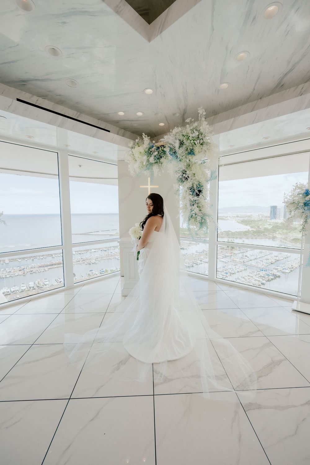 White wedding dress displayed in a modern bright room with Kelehua as officiant from marry me Hawaii