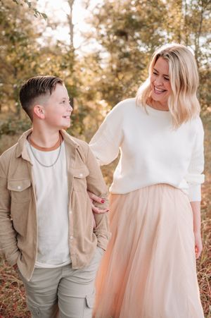 A heartwarming outdoor photoshoot featuring neutral tones and warm autumn lighting in a natural setting.