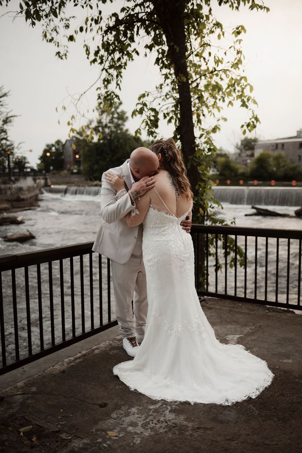 A romantic wedding couple embraces on a scenic overlook during golden hour, creating a series of intimate moments.