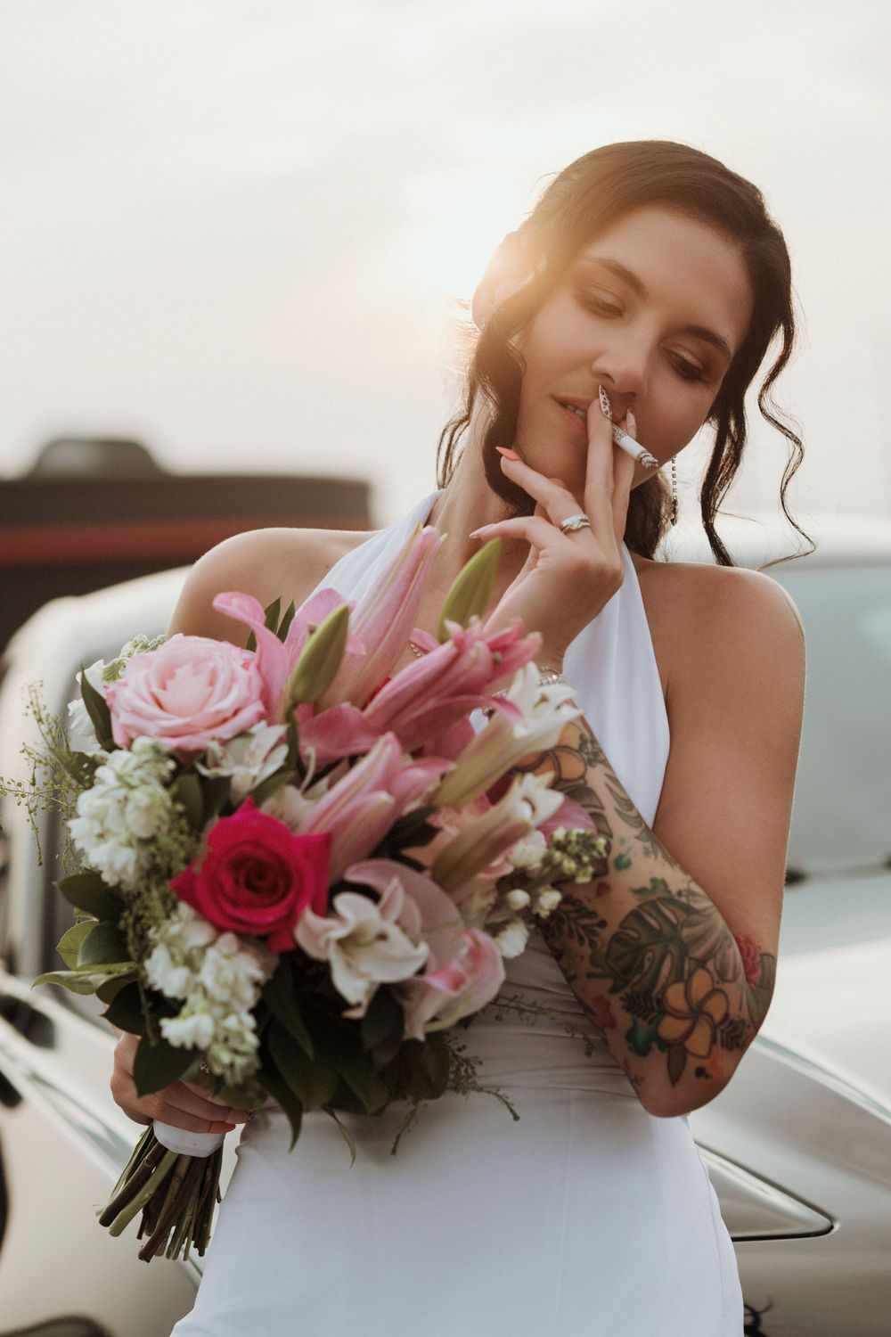 A bridal bouquet series featuring pink and white flowers held by someone in a white wedding dress.