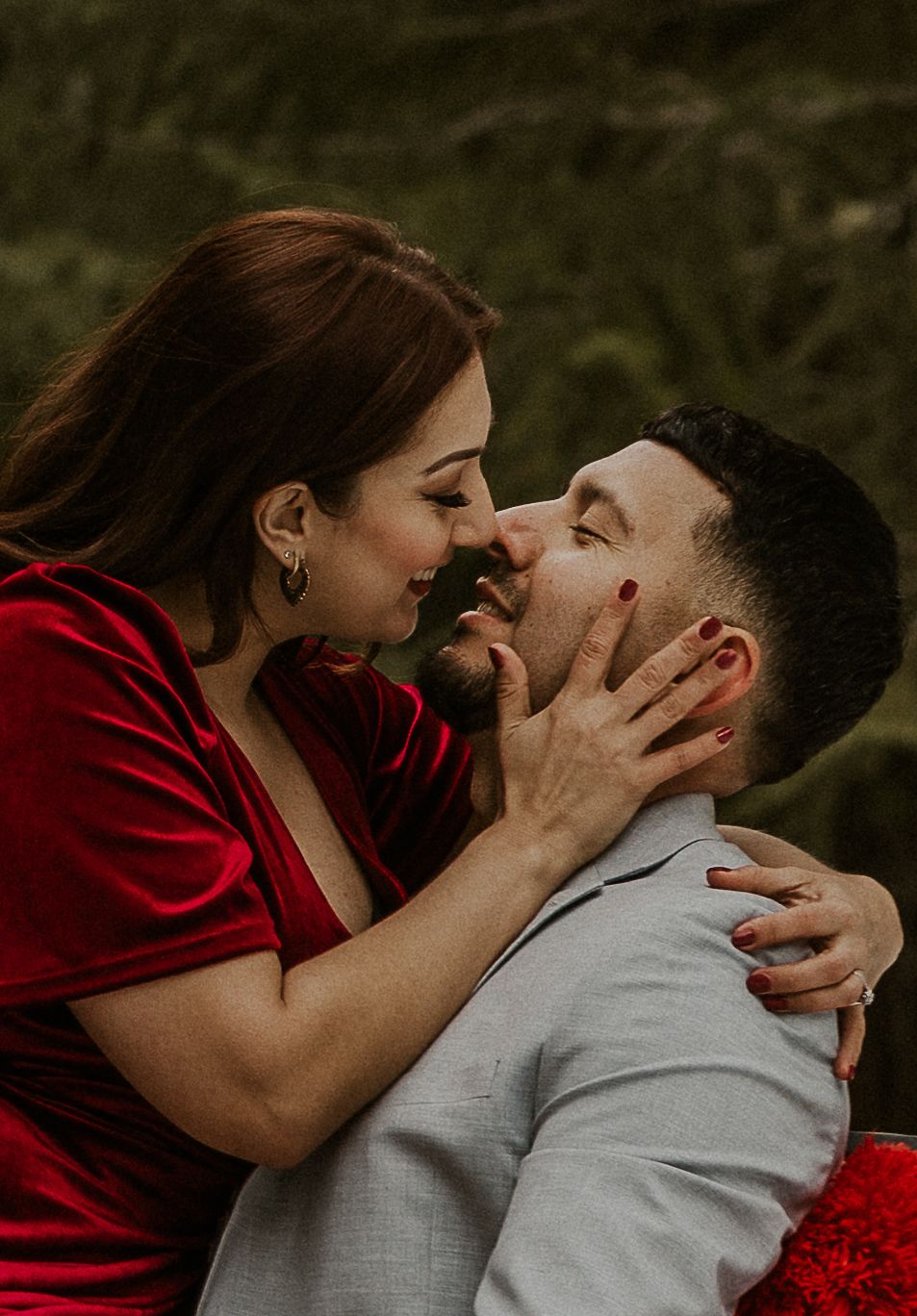 Intimate couple sharing passionate moment in romantic outdoor setting.