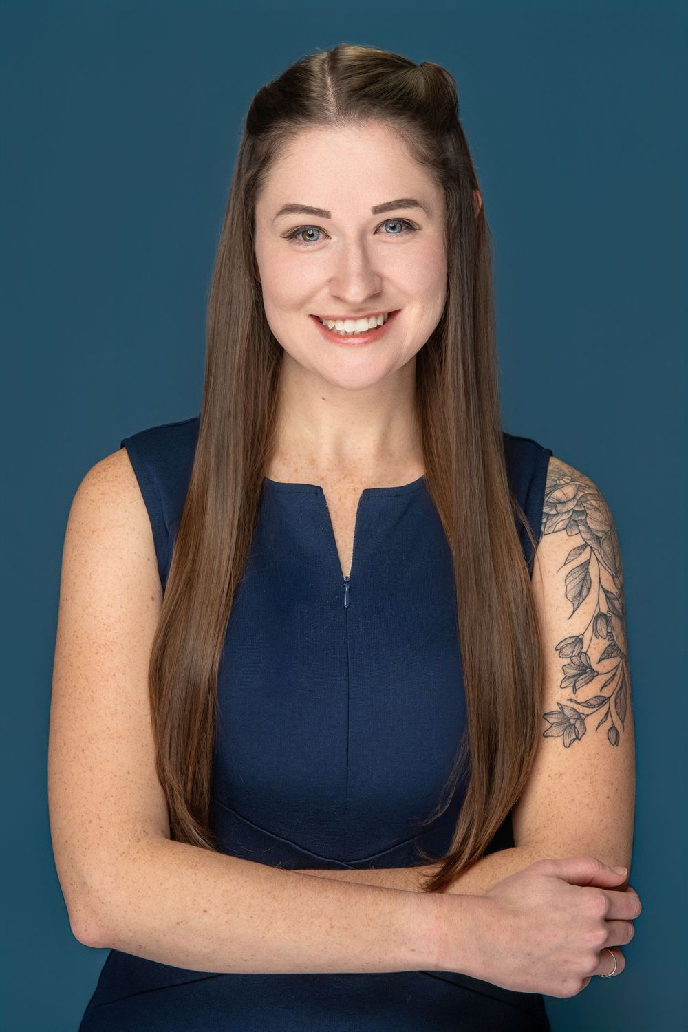 Professional portrait series showing a person in a sleeveless navy dress against a blue backdrop.