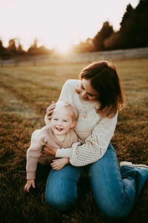 Sweet candid moments captured during sunset family photo session.