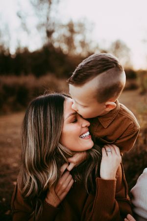 Intimate close-up moments shared between parent and child in warm sunset light.