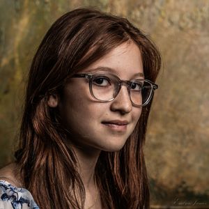 Portrait photo taken from various angles showing long brown hair and glasses against a textured brown backdrop.