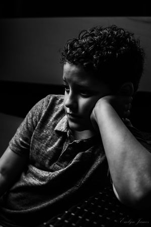 A sequence of eight black and white moody portraits showing a dark silhouette against a shadowy background.