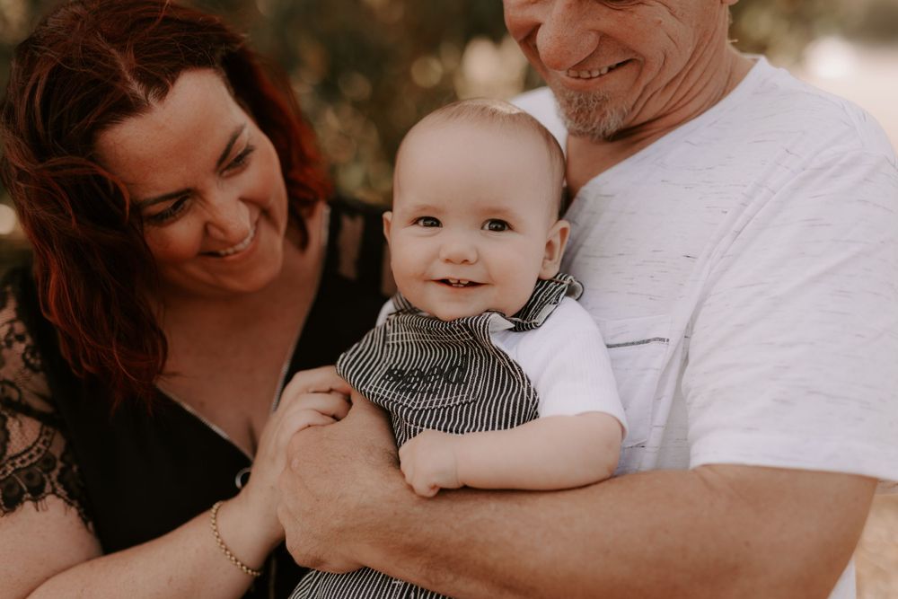 Tender family moment captured with baby in casual indoor setting.