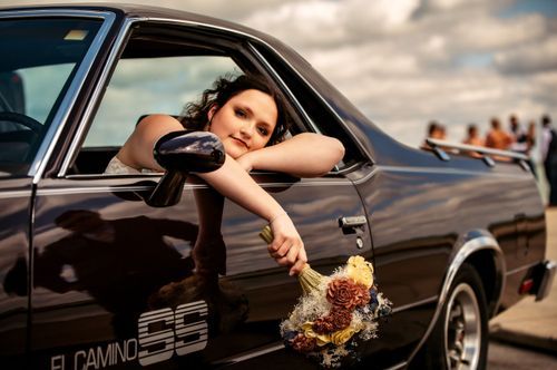 Bride leaning out of muscle car in West Central Ohio.
