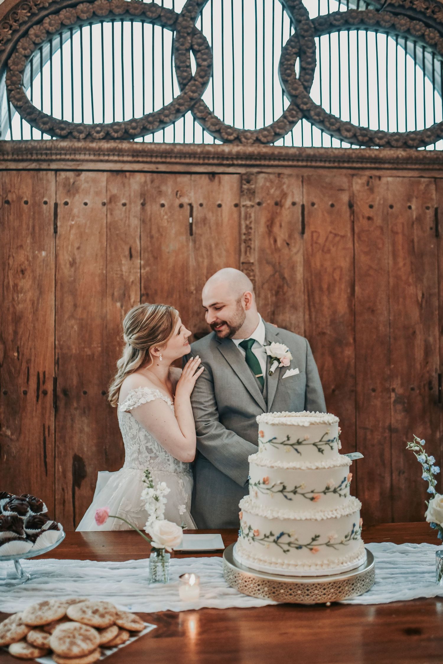 Newlyweds laughing together during their wedding cake cutting