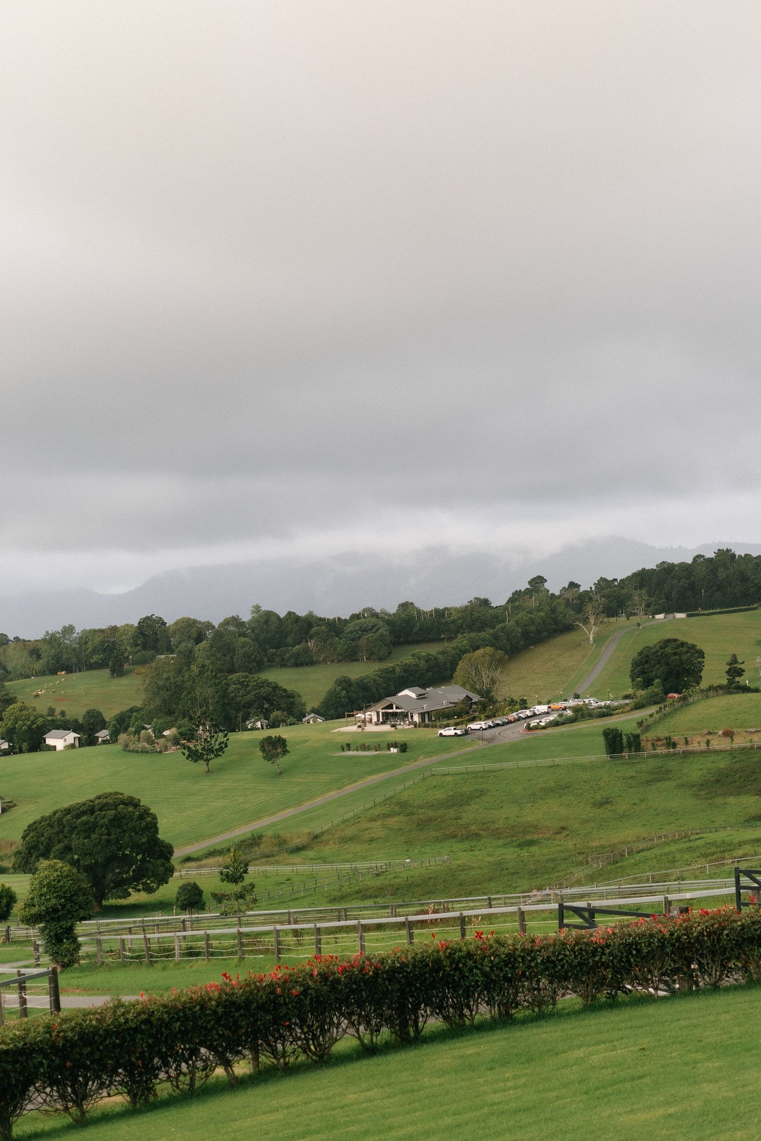 Scenic countryside wedding venue on rolling green hills under a dramatic overcast sky.