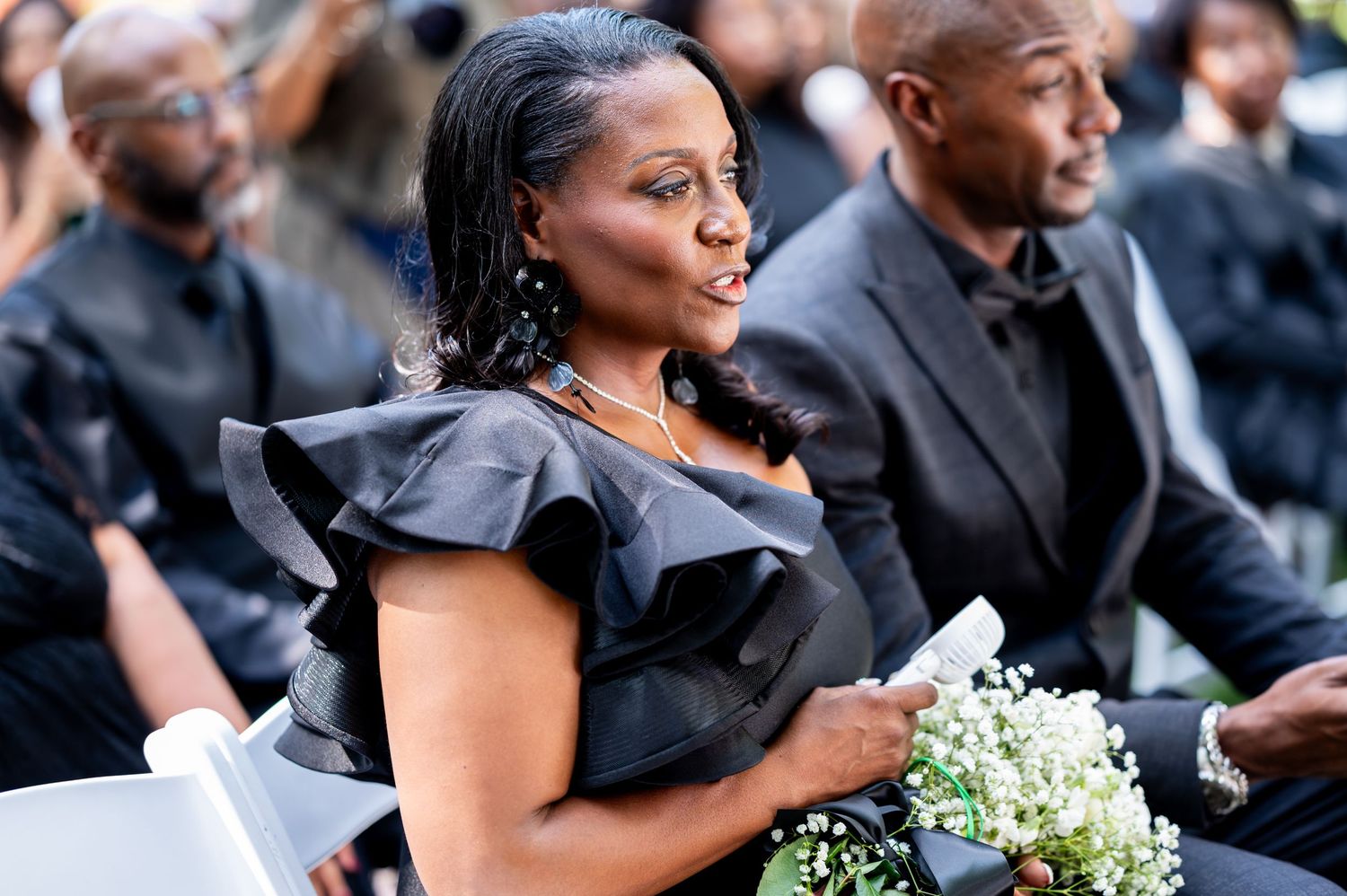 The mother of the groom looks on as the ceremony proceeds at Flagler Museum in Palm Beach, Florida.
