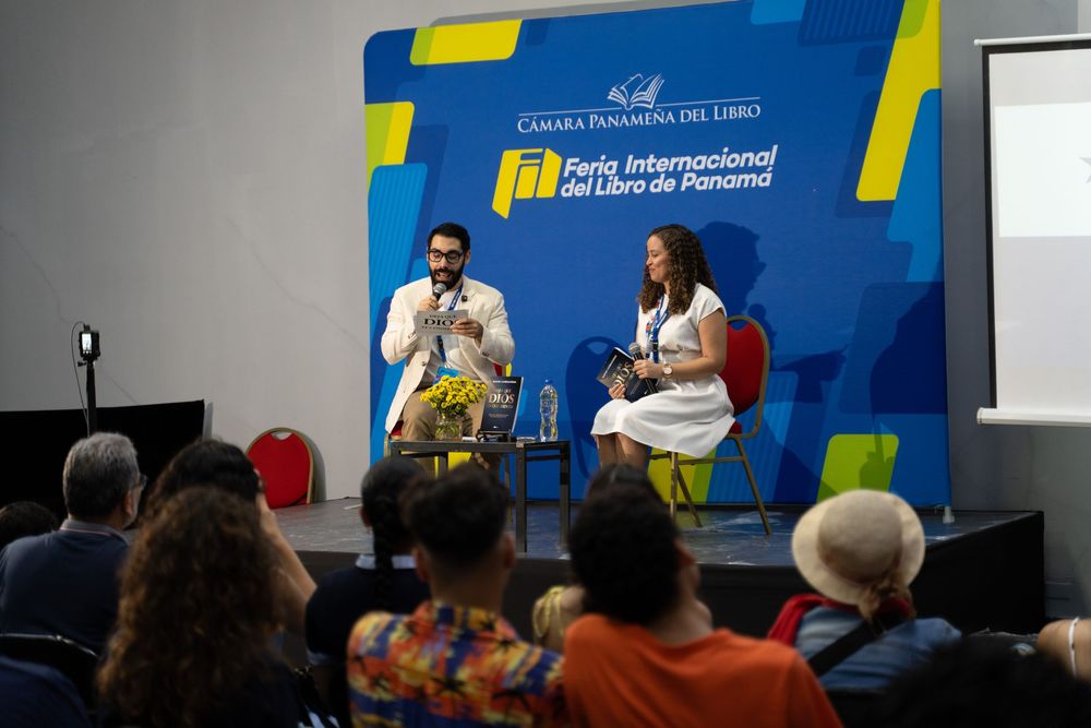 Two speakers present at the Feria Internacional del Libro de Panama book fair event on stage.
