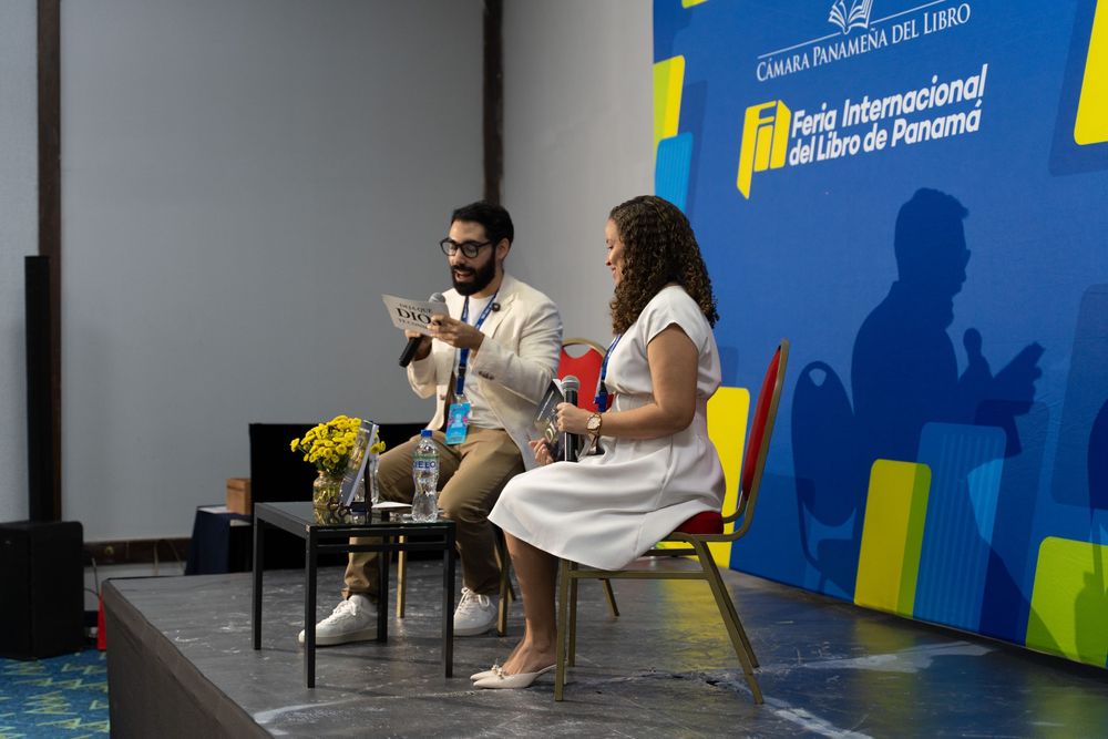 Two speakers present on stage at the Feria Internacional del Libro de Panama book fair event.