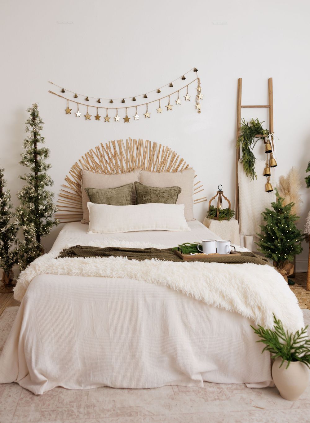 Boho Christmas bedroom with rattan headboard, faux fur throw, star garland, and festive green trees.