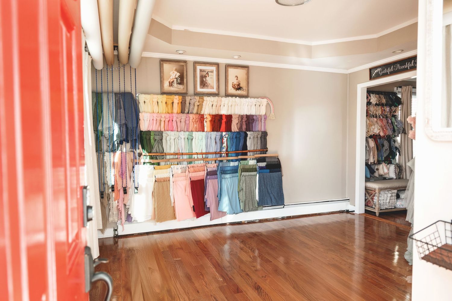 Private photography studio in Linden, New Jersey with newborn wraps, props, and client wardrobe displayed.