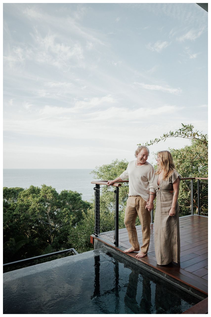 Romantic Vacation Photos at One & Only Mandarina Resort with a couple overlooking the tropical forest from an infinity pool.