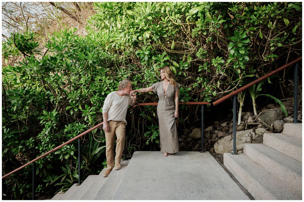 Couples Photo Session at One & Only Mandarina Resort with an engaged couple sharing an intimate moment among lush tropical foliage.