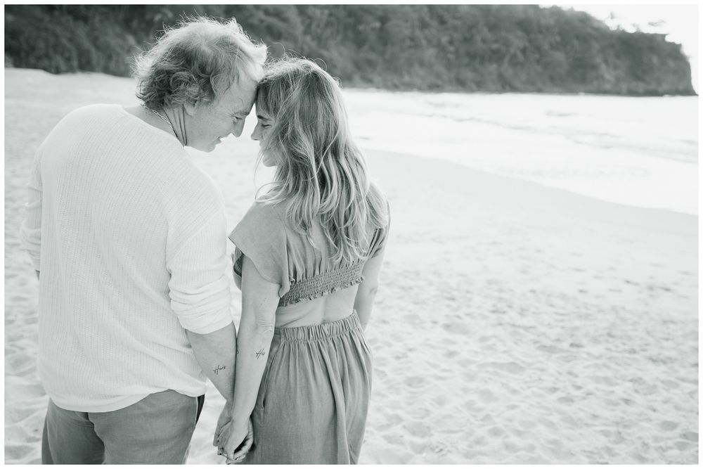 Luxury Couple Photography at One & Only Mandarina Resort with partners holding hands and touching foreheads by the ocean.