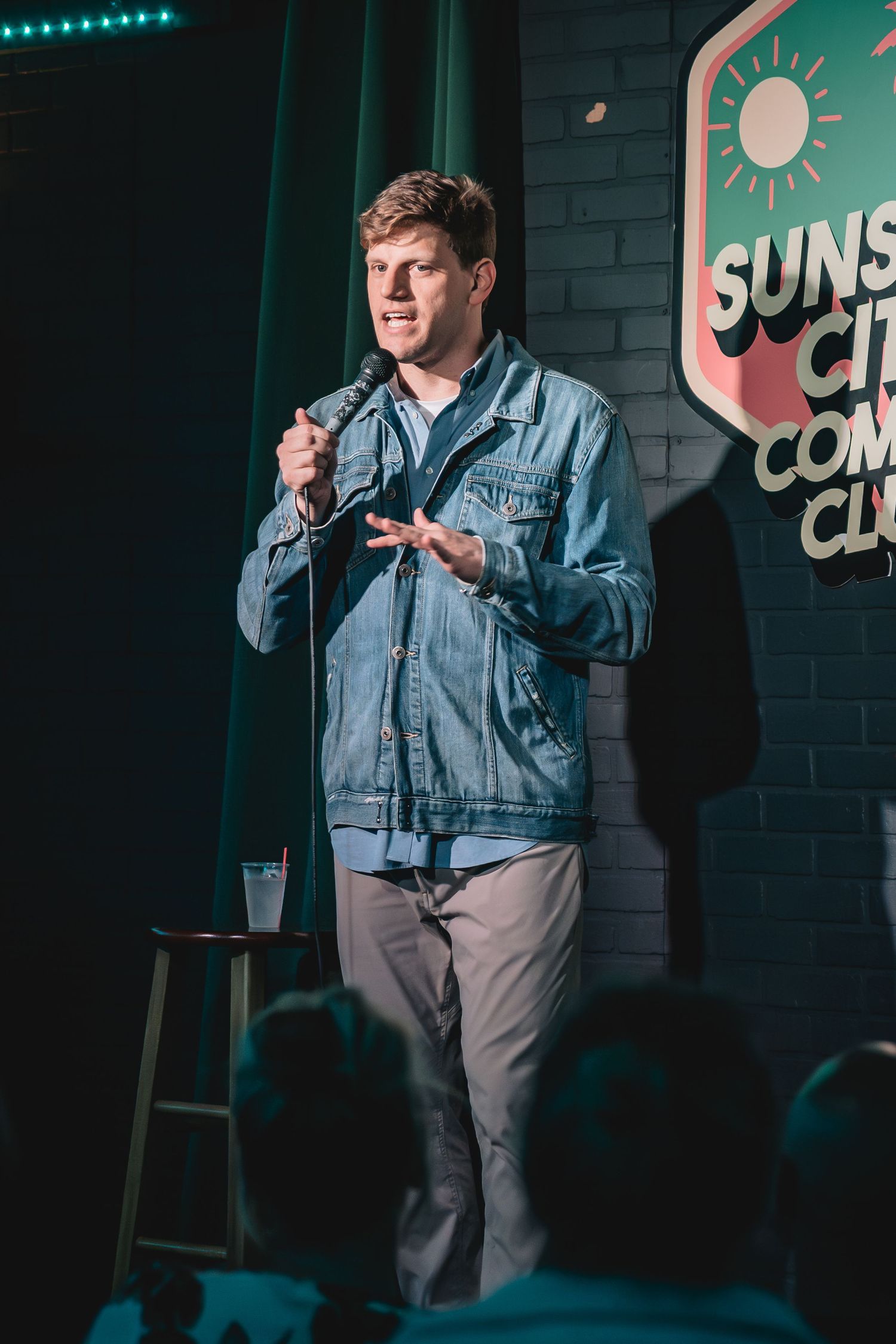 Dedrick Flynn the comedian performing stand-up comedy on stage holding a microphone at Side Splitters Comedy Club Tampa. Videography. Photo