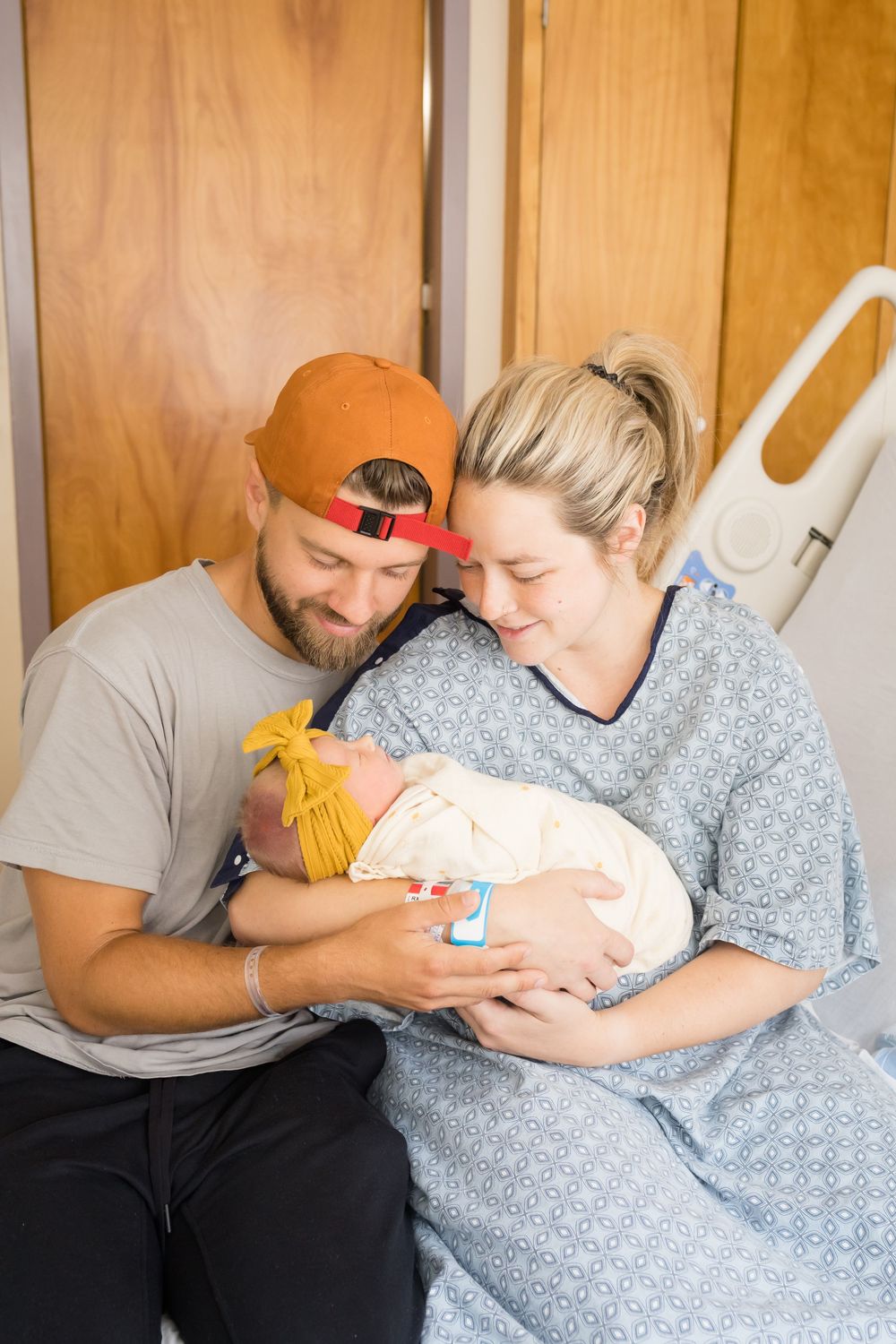 Parents smiling at their newborn baby in a hospital room. Images at Fort Sanders Medical Center in Knoxville, TN by Nina Thomas Photography.