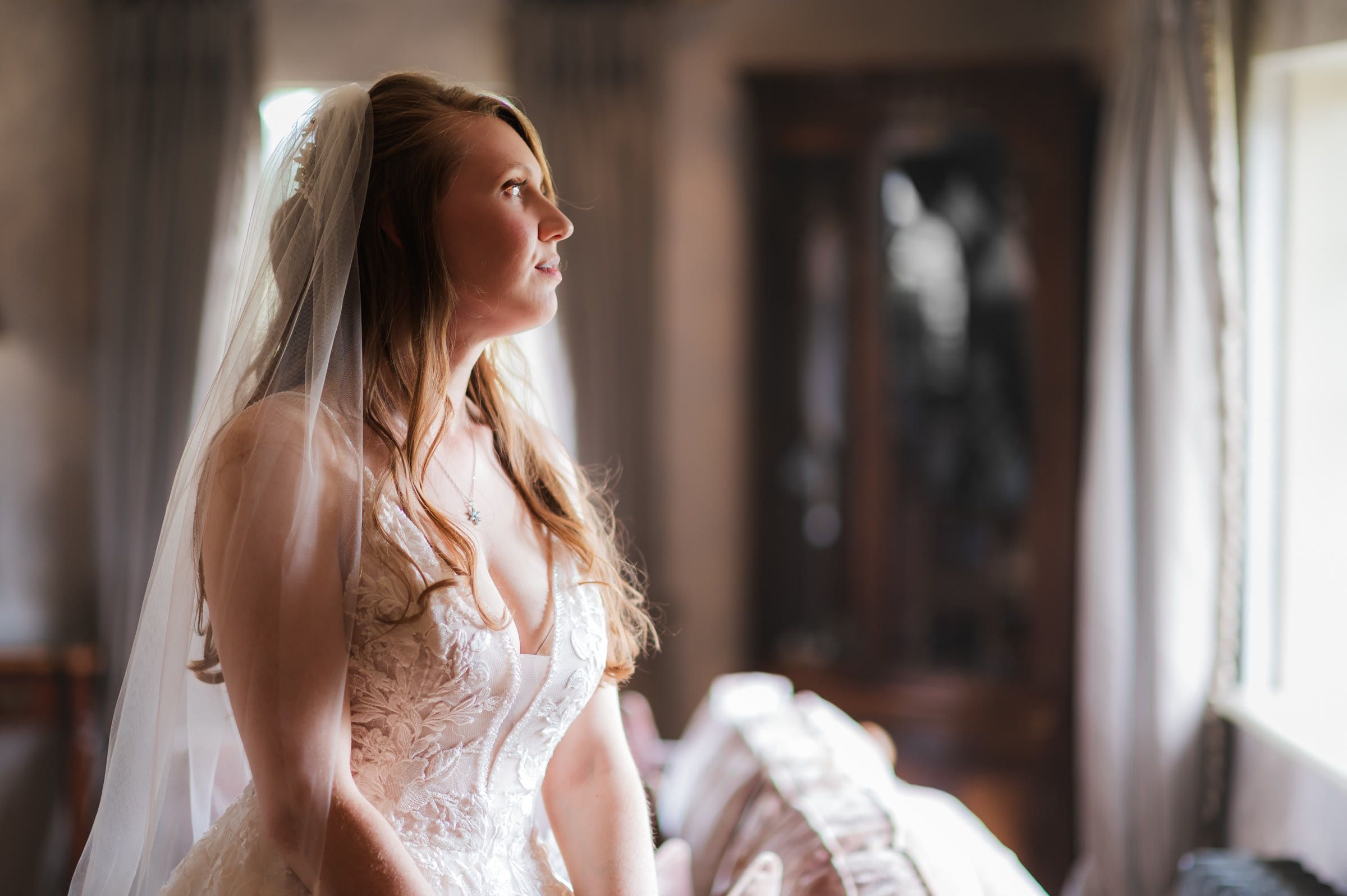 Charlotte by the window in her dress at Merrydale Manor, Cheshire