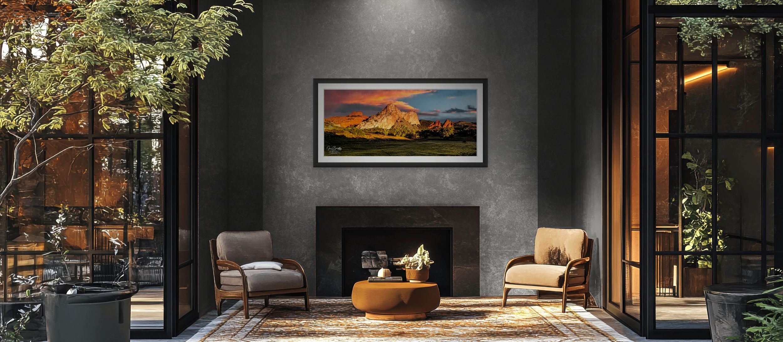 Elegant living room with dark walls, fireplace, two chairs, and a vibrant mountain landscape painting above the mantel.