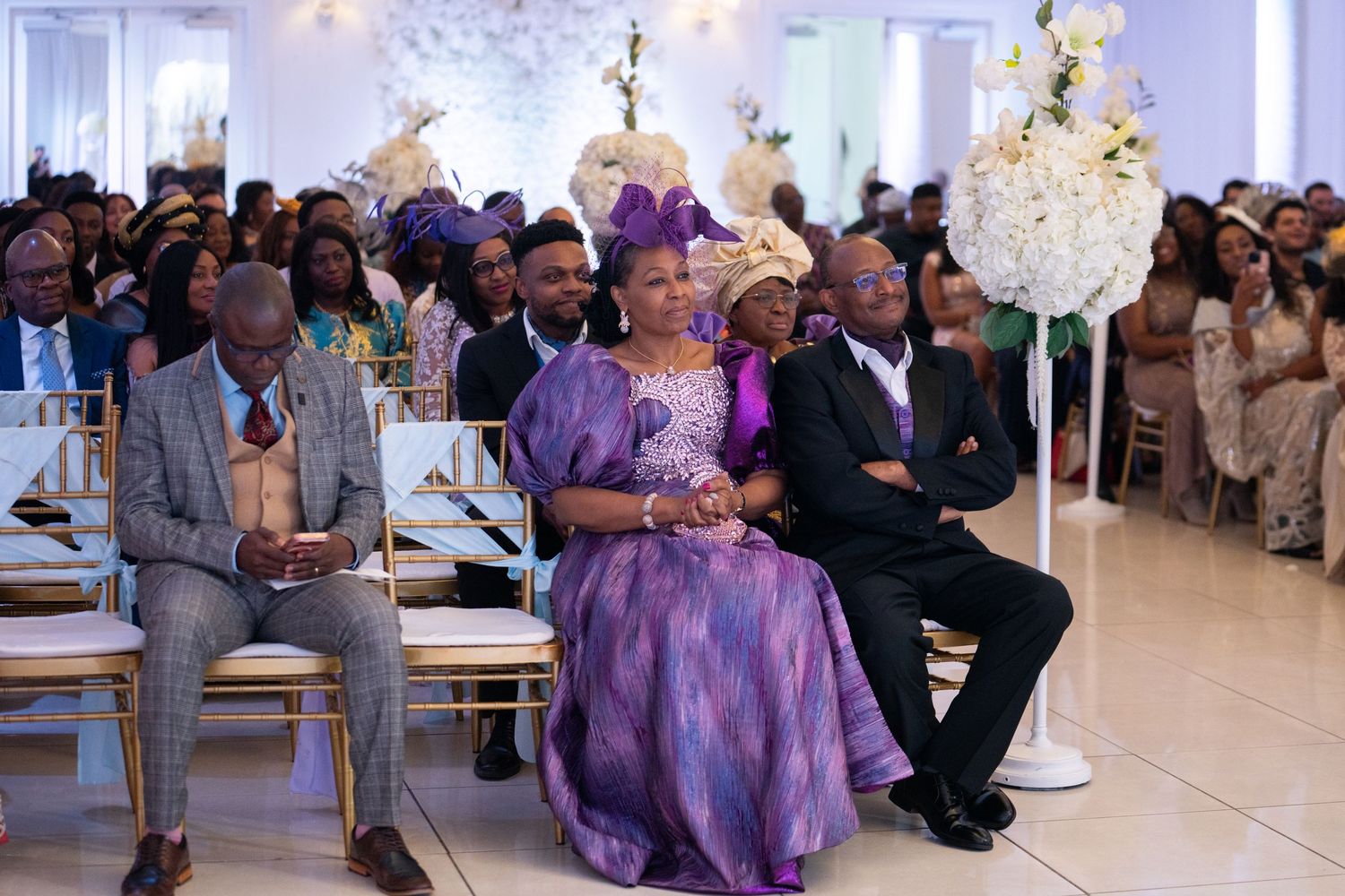 Nigerian wedding guests seated ceremony candid photography Orlando Florida