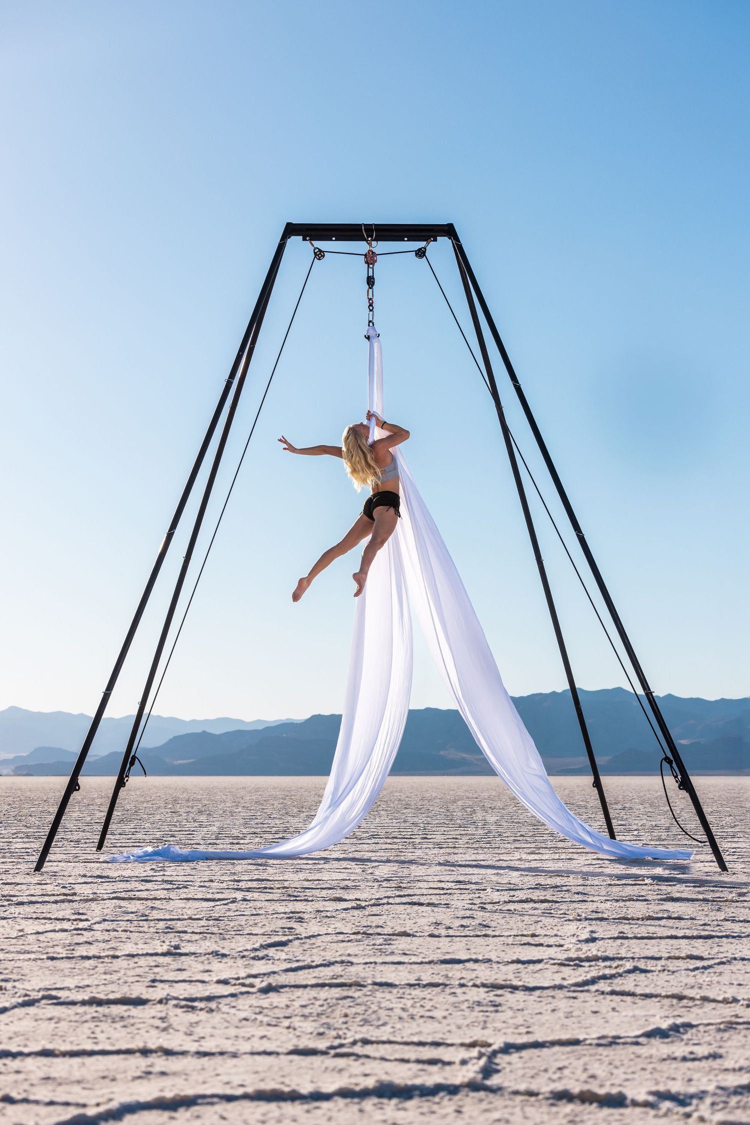 Aerialist in studio on white backdrop; professional aerial arts photography, aerial portraits, and aerialist photoshoot by expert photograph