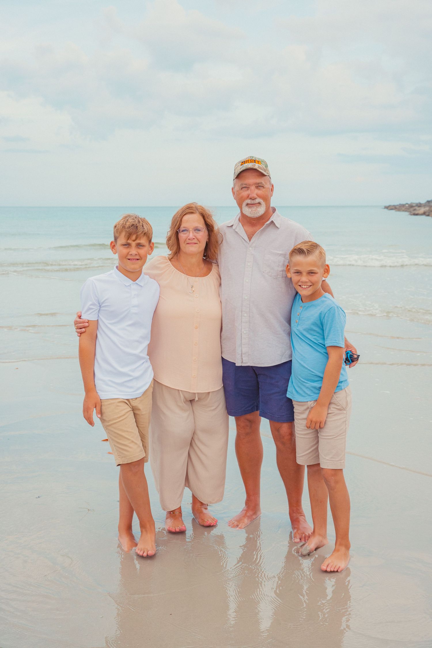 Grandparents hug their two grandsons during a family picture session on the Treasure Coast of Florida.