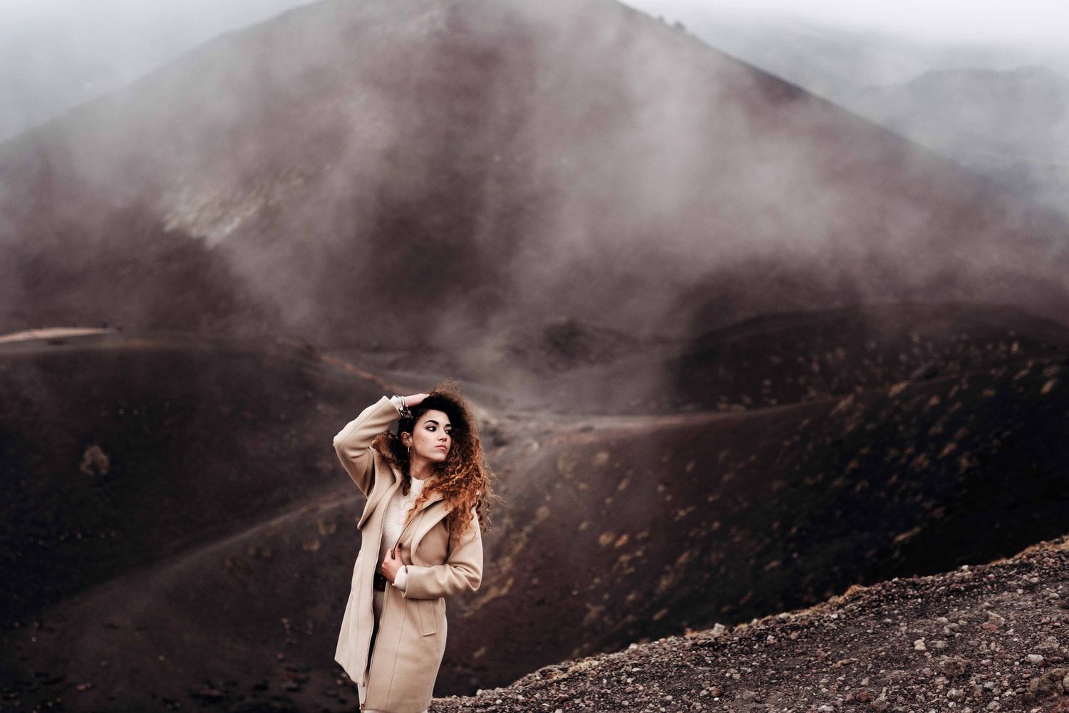 Woman at golden hour on the black lava of Mount Etna — photo experience in Sicily