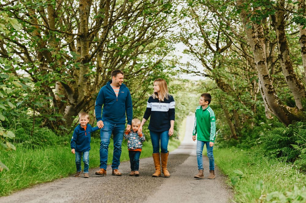 Group taking a scenic walk together on a peaceful tree-lined path in nature.